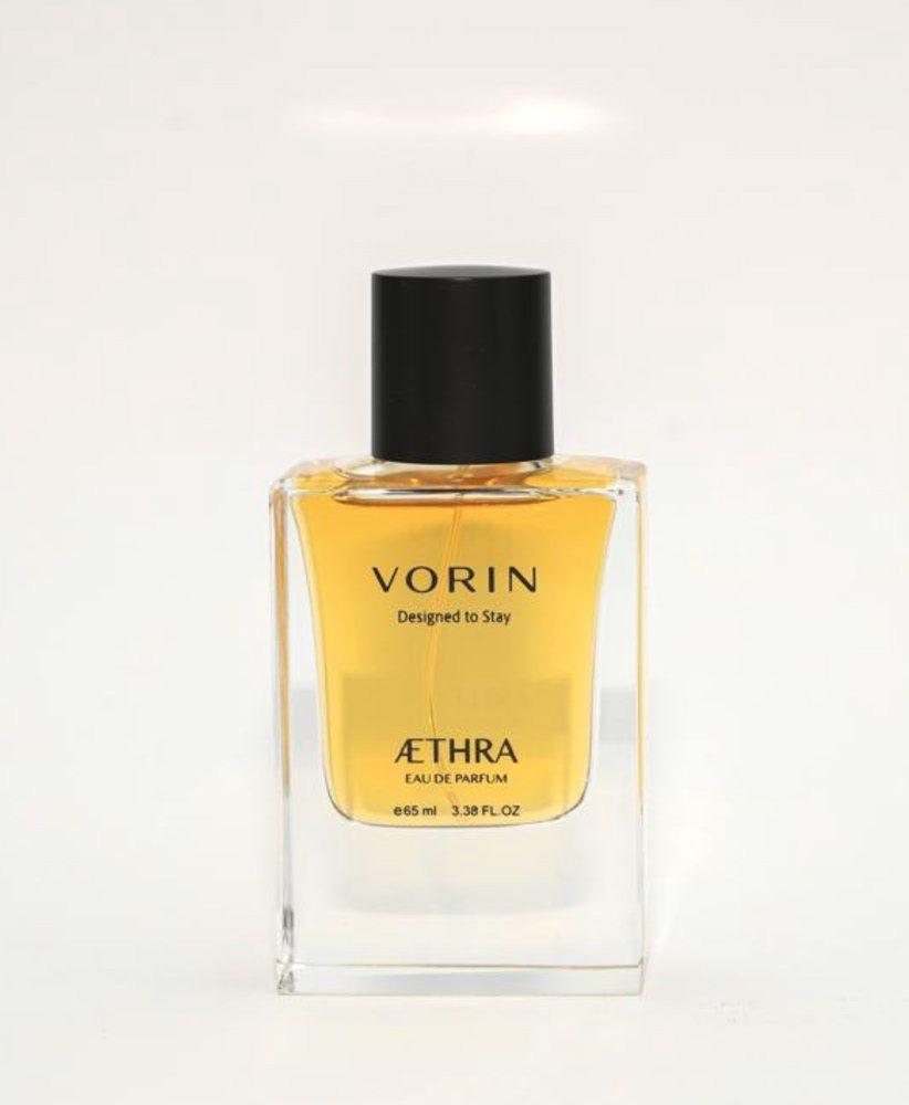 AETHRA eau de parfum bottle, amber liquid with a black cap